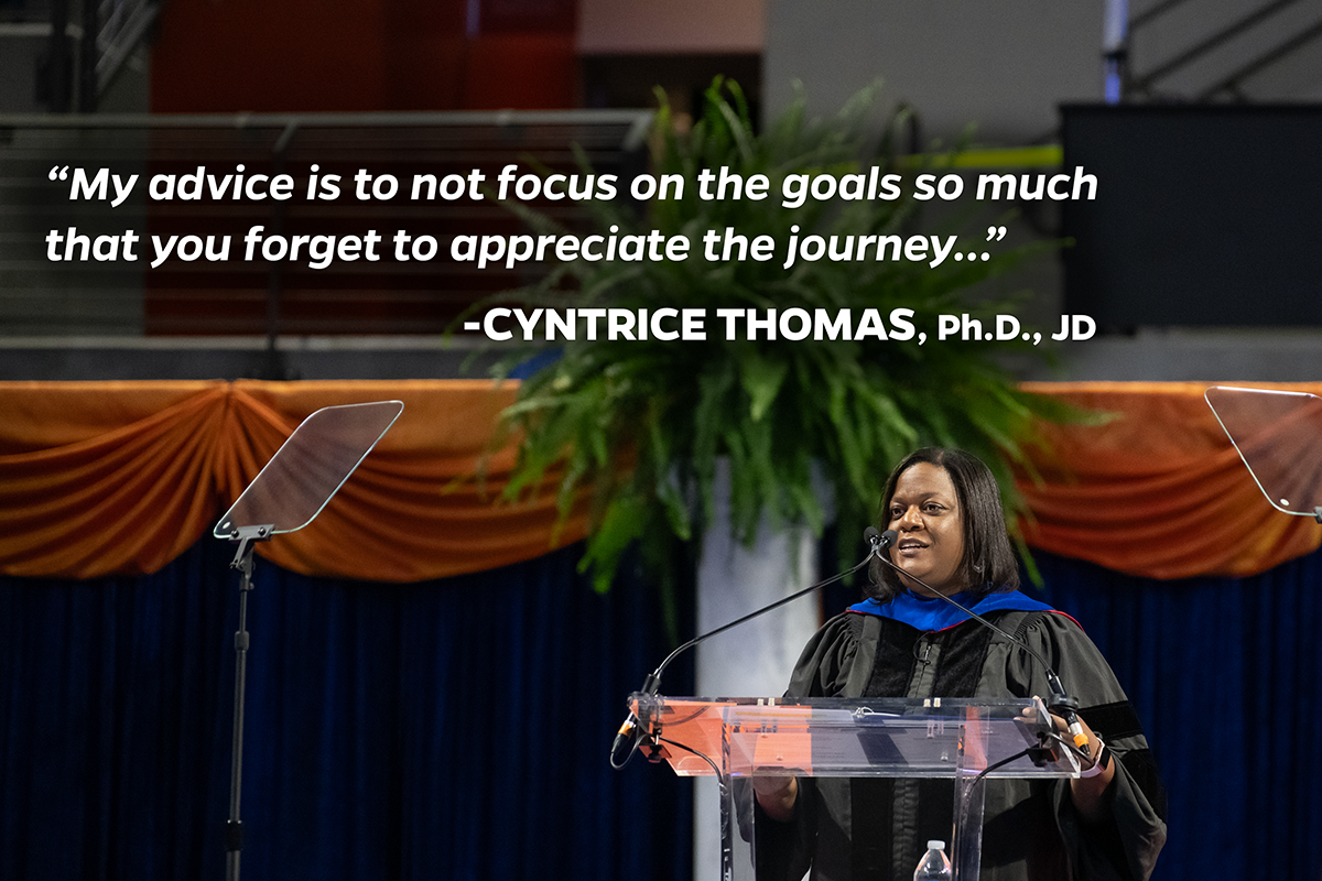 Cyntrice Thomas addresses the Class of 2024 at the University of Florida College of Health & Human Performance Spring Recognition Ceremony on Thursday, May 2, 2024. Above her is the following quote:  “My advice is to not focus on the goals so much that you forget to appreciate the journey…”